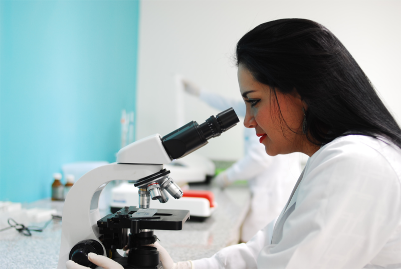 Researcher Using A Microscope In Lab R